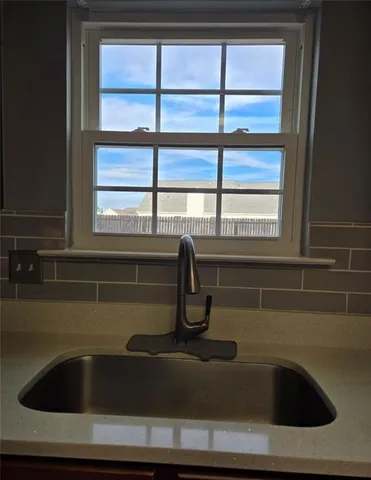 a large kitchen with stainless steel appliances granite countertop a stove and a sink