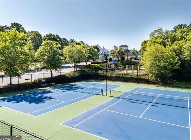 a spacious bathroom with double vanity and a tub