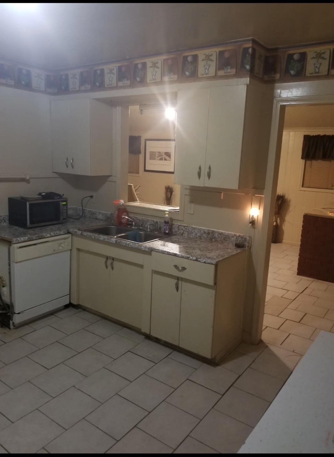 1505 Titus Road Memphis, TN 38111 - Photo 13 of 14 a kitchen with a sink and cabinets