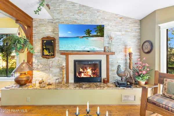 a living room with wooden floors and furniture