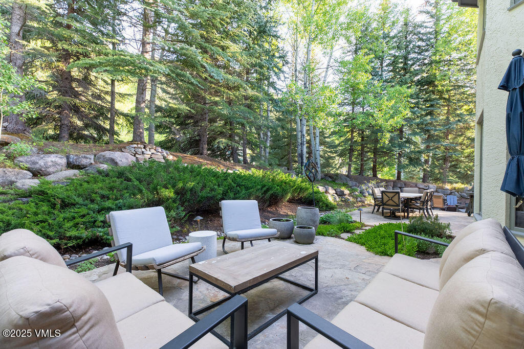 4 Ambleside Place Edwards, CO 81632 - Photo 11 of 22 a view of a patio with couches table and chairs with plants and trees