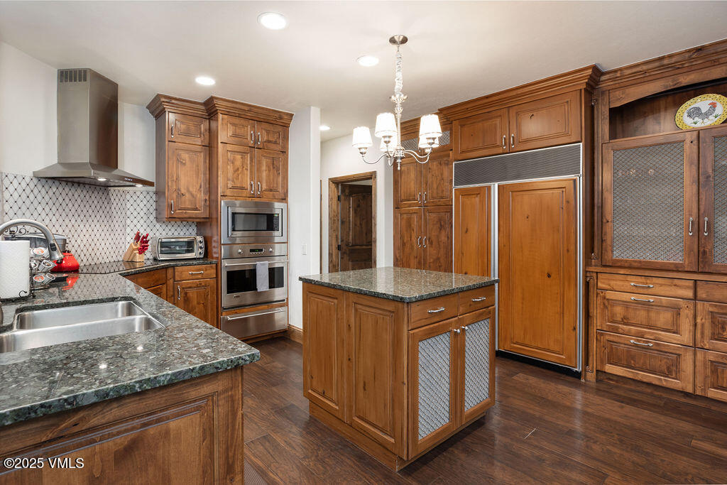 4 Ambleside Place Edwards, CO 81632 - Photo 17 of 22 a kitchen with stainless steel appliances granite countertop a refrigerator a oven and a stove with wooden floor