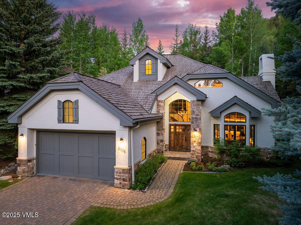 4 Ambleside Place Edwards, CO 81632 - Photo 2 of 22 a front view of a house with a yard and garage
