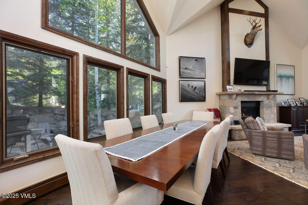 4 Ambleside Place Edwards, CO 81632 - Photo 6 of 22 a view of a dining room with furniture a flat screen tv and floor to ceiling window