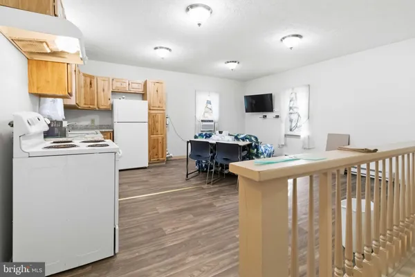 a kitchen that has a lot of white cabinets and stainless steel appliances