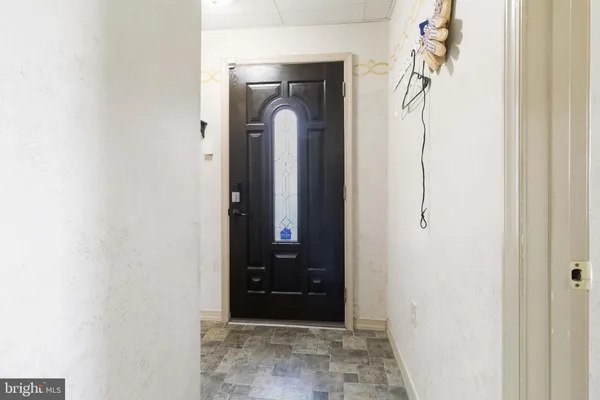 a view of a entryway door with a hallway