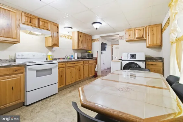 a kitchen with a stove a sink and a refrigerator