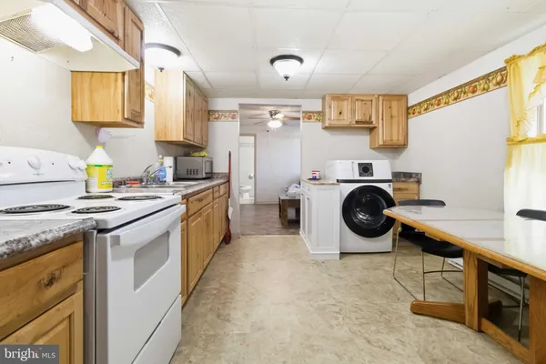 a kitchen with a stove top oven sink and cabinets