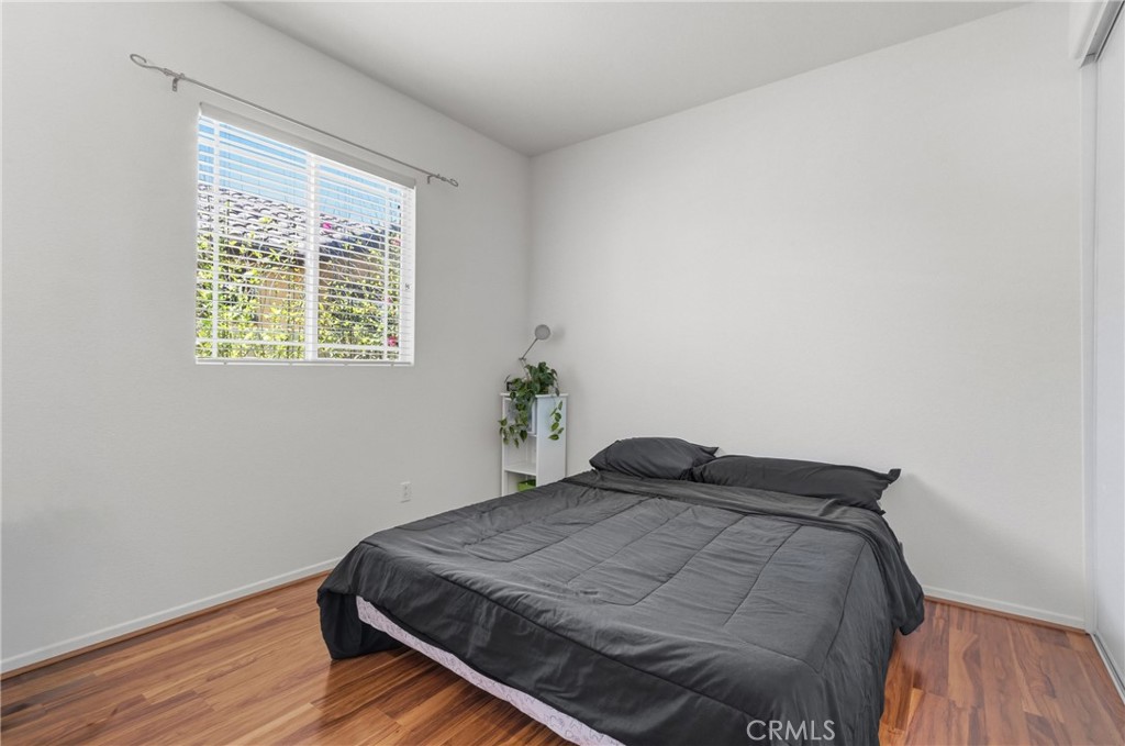 33145 Vermont Road Temecula, CA 92592 - Photo 29 of 41 a bedroom with a bed and wooden floor