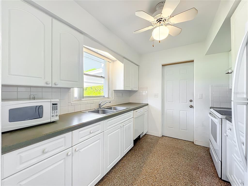 1401 Orange Tree Drive Edgewater, FL 32132 - Photo 13 of 46 a kitchen with a sink and cabinets