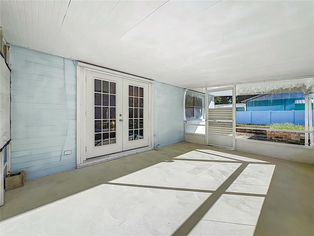 1401 Orange Tree Drive Edgewater, FL 32132 - Photo 31 of 46 a living room with a couch and a stove next to a window