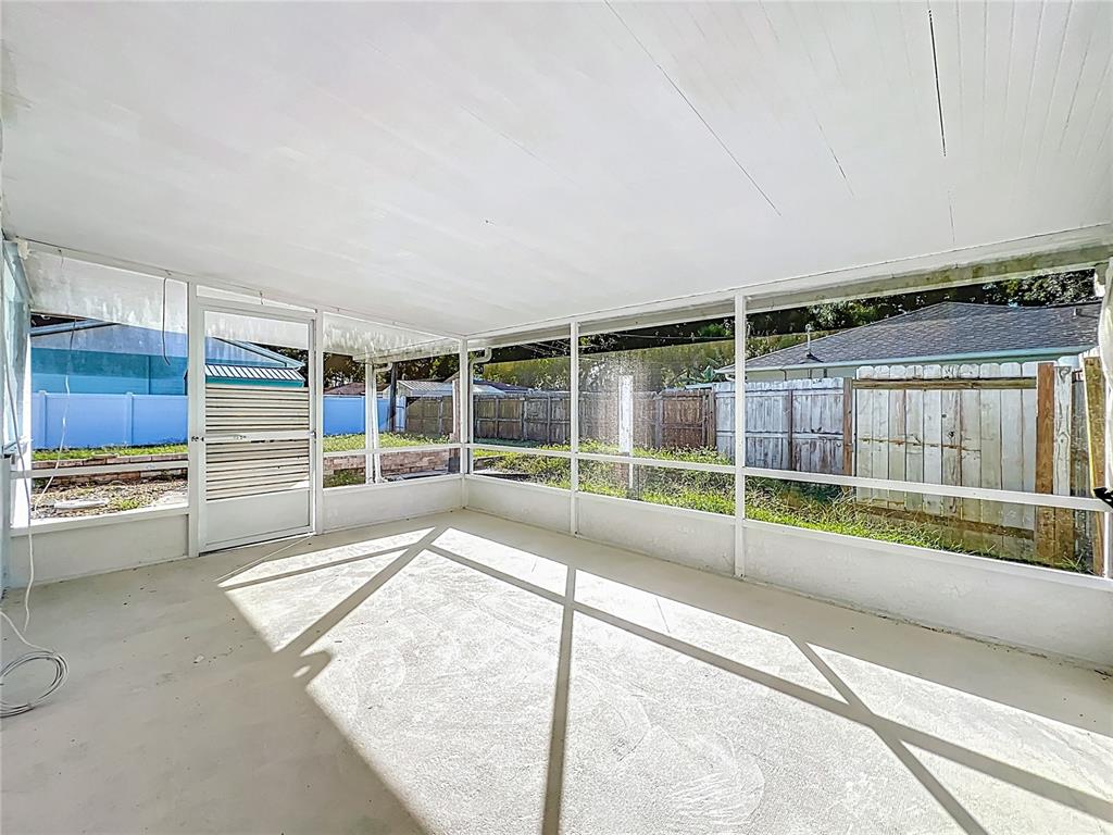 1401 Orange Tree Drive Edgewater, FL 32132 - Photo 32 of 46 a view of an empty room with wooden floor and windows