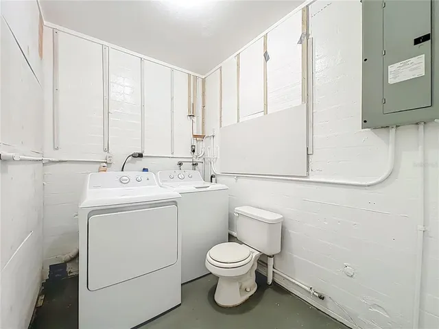 a view of a house with a big yard plants and large tree
