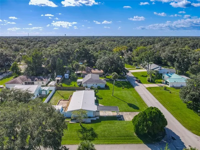 an aerial view of a house with a yard