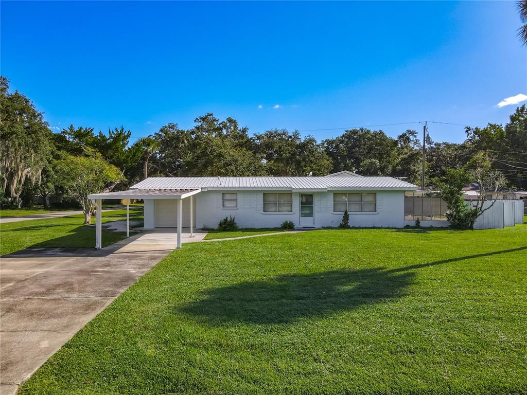 1401 Orange Tree Drive Edgewater, FL 32132 - Photo 44 of 46 a front view of a house with garden