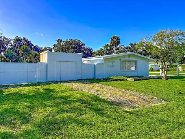 a view of yard with swimming pool and green space