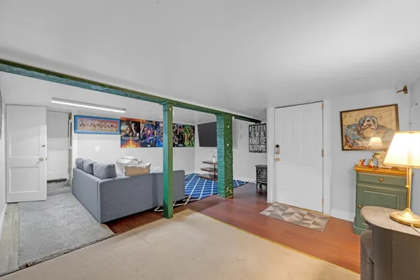 a living room with furniture and a clock
