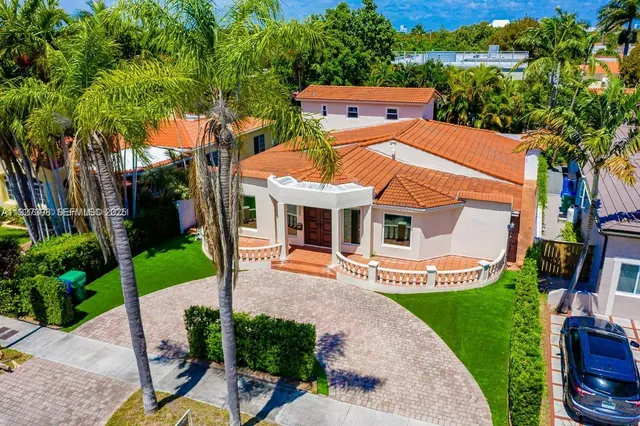 an aerial view of a house with a yard basket ball court and outdoor seating
