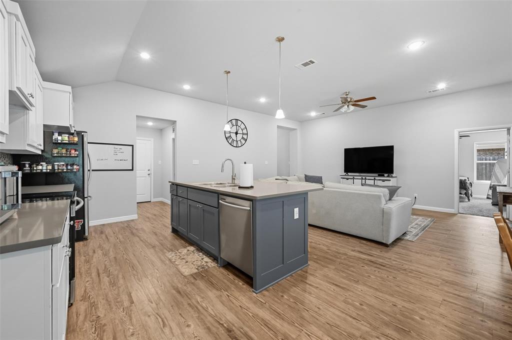 977 Sam Street Springtown, TX 76082 - Photo 28 of 29 a large living room with stainless steel appliances granite countertop a couch and a flat screen tv