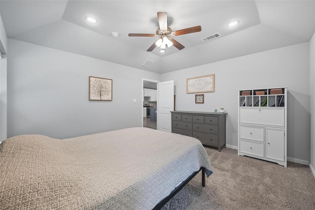 977 Sam Street Springtown, TX 76082 - Photo 16 of 29 a bedroom with a bed and a dresser