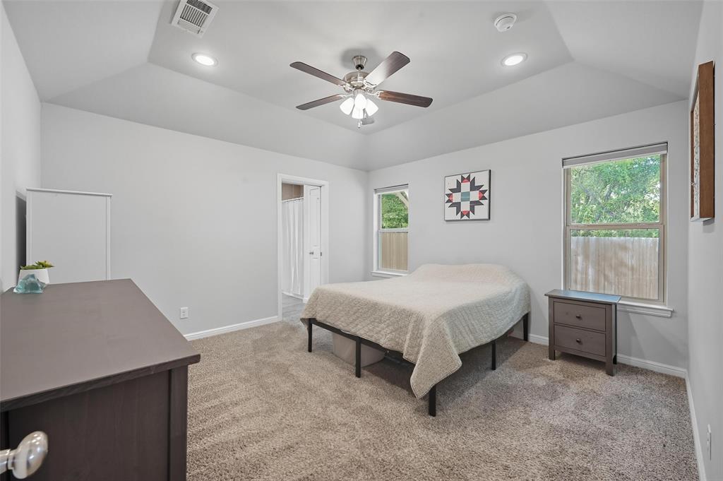 977 Sam Street Springtown, TX 76082 - Photo 17 of 29 a spacious bedroom with a bed and a desk