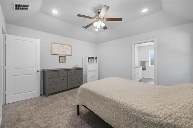 a bedroom with a bed and a dresser