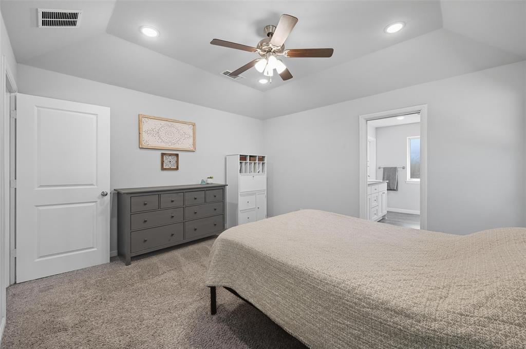 977 Sam Street Springtown, TX 76082 - Photo 18 of 29 a bedroom with a bed and a dresser