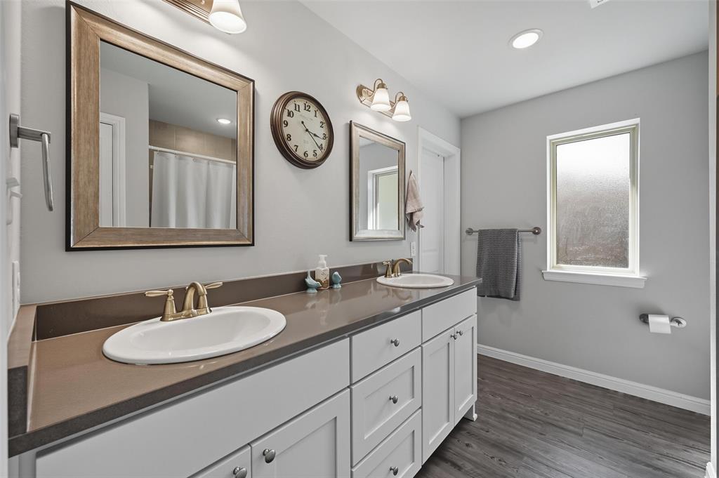 977 Sam Street Springtown, TX 76082 - Photo 19 of 29 a bathroom with a granite countertop sink and a mirror