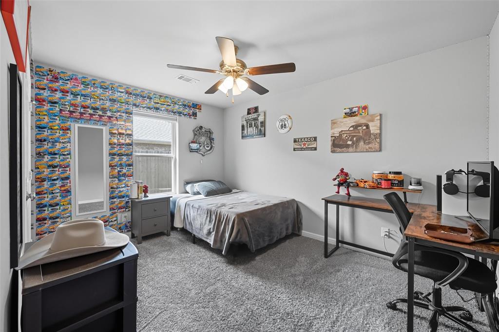 977 Sam Street Springtown, TX 76082 - Photo 21 of 29 a bedroom with a bed and a desk