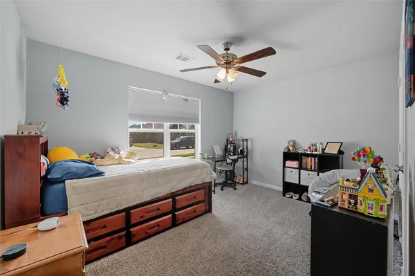 a bedroom with a bed and a desk