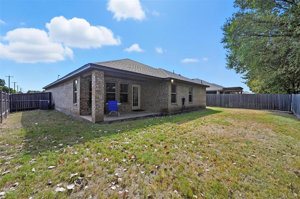 977 Sam Street Springtown, TX 76082 - Photo 25 of 29 a view of a house with a backyard