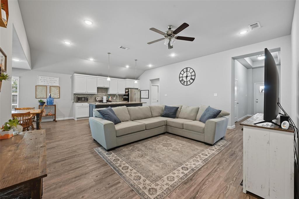 977 Sam Street Springtown, TX 76082 - Photo 4 of 29 a living room with furniture and a flat screen tv