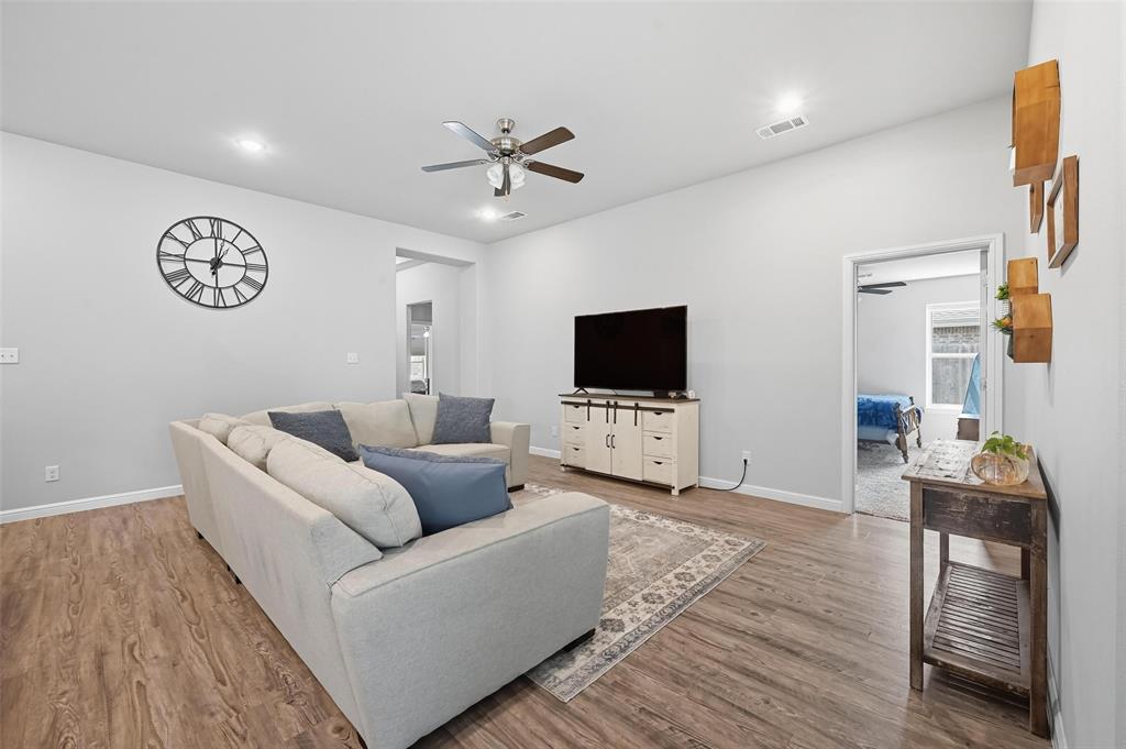 977 Sam Street Springtown, TX 76082 - Photo 6 of 29 a living room with furniture and a flat screen tv