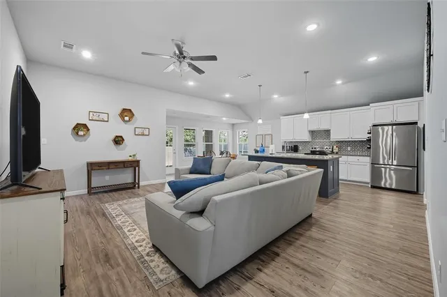 a living room with furniture and a flat screen tv
