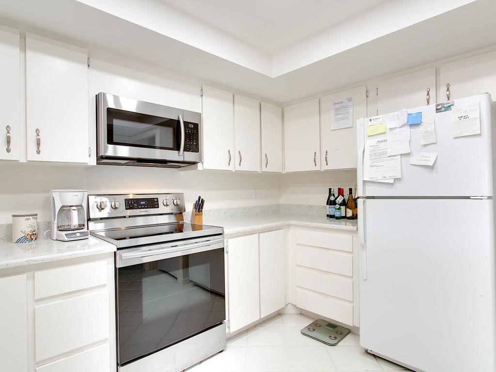 1880 Bay Road, Unit 220I Vero Beach, FL 32963 - Photo 13 of 35 a kitchen with cabinets appliances and a sink
