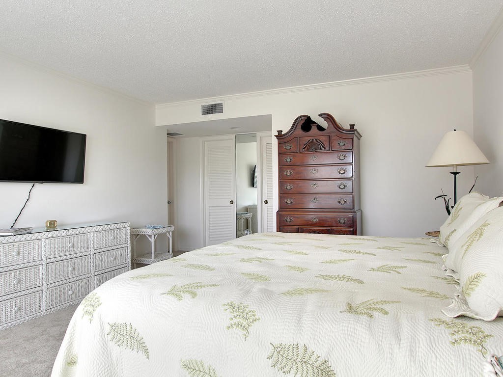 1880 Bay Road, Unit 220I Vero Beach, FL 32963 - Photo 15 of 35 a bedroom with a bed and a flat screen tv