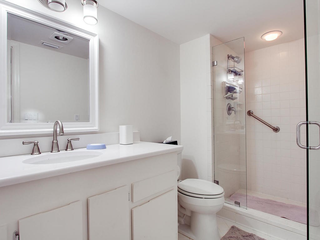 1880 Bay Road, Unit 220I Vero Beach, FL 32963 - Photo 17 of 35 a bathroom with a sink a toilet and shower