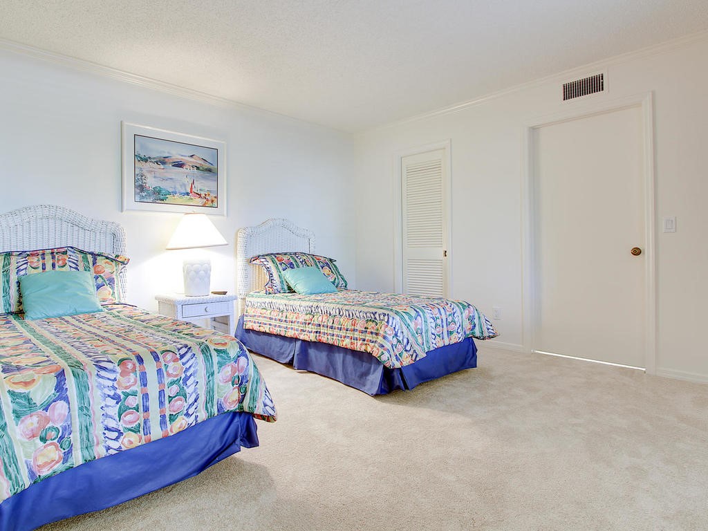 1880 Bay Road, Unit 220I Vero Beach, FL 32963 - Photo 19 of 35 a bedroom with a bed and painting on the wall