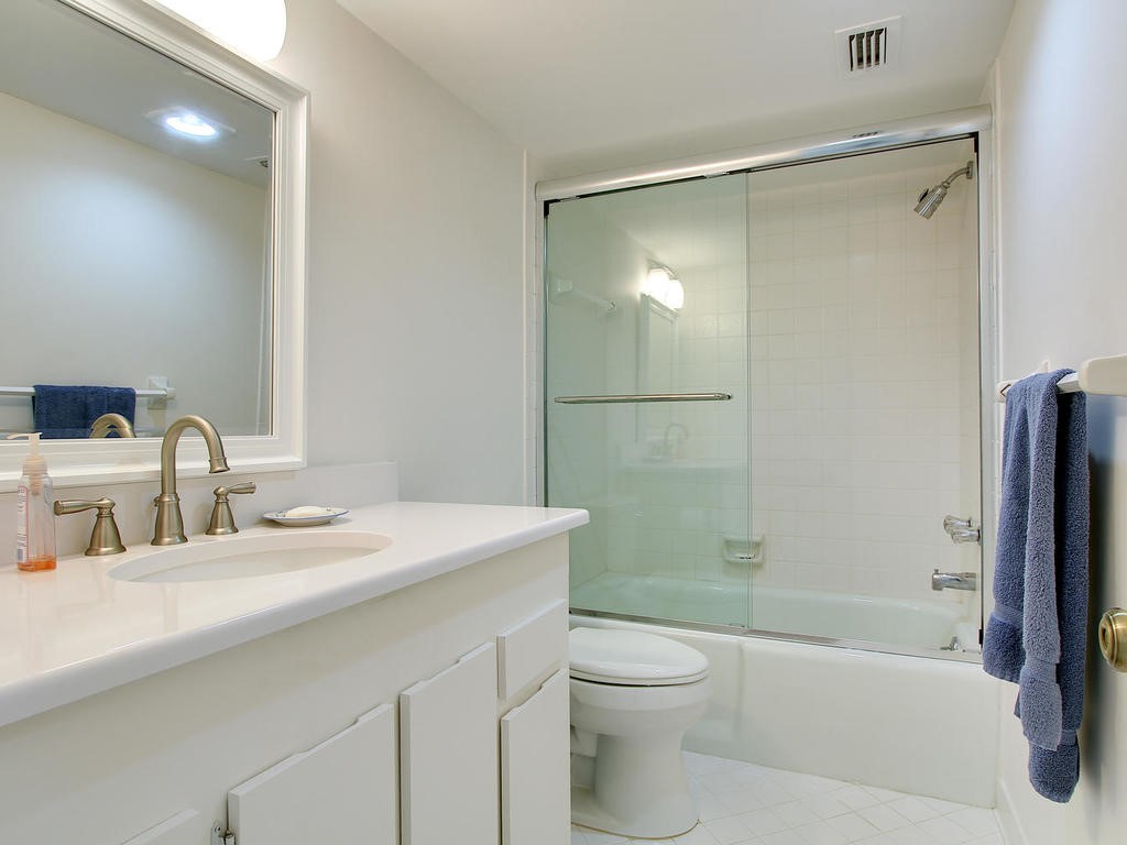 1880 Bay Road, Unit 220I Vero Beach, FL 32963 - Photo 20 of 35 a bathroom with a sink toilet and shower