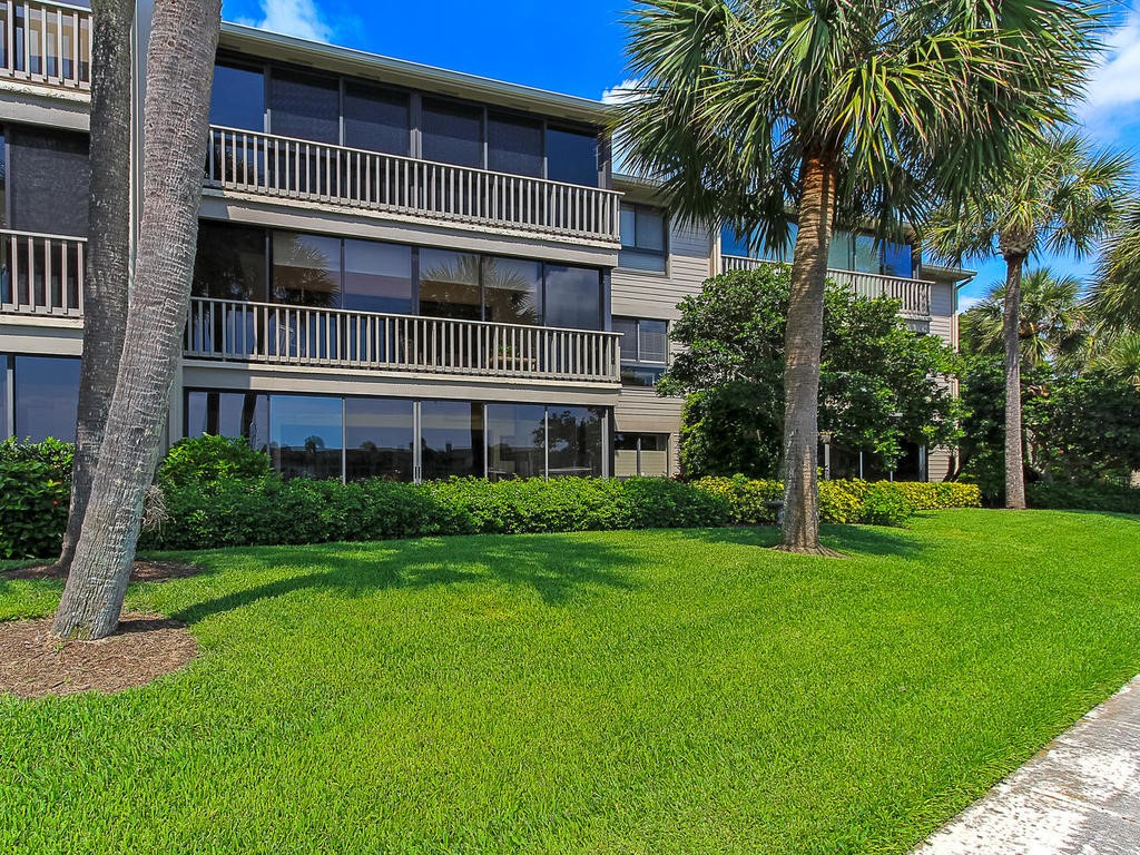 1880 Bay Road, Unit 220I Vero Beach, FL 32963 - Photo 22 of 35 a front view of a house with a yard