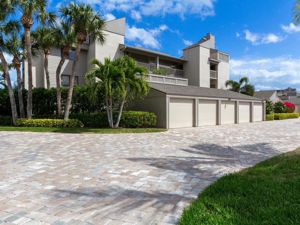 1880 Bay Road, Unit 220I Vero Beach, FL 32963 - Photo 23 of 35 a front view of a house with a yard and trees