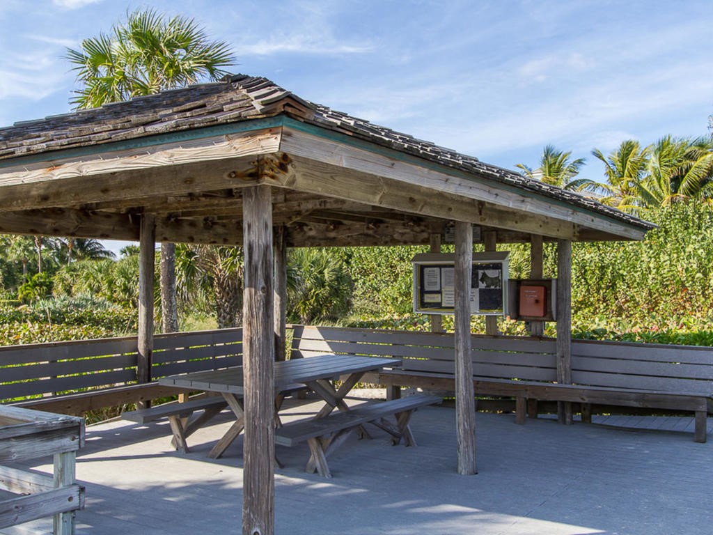 1880 Bay Road, Unit 220I Vero Beach, FL 32963 - Photo 33 of 35 a backyard of a house with barbeque oven table and chairs