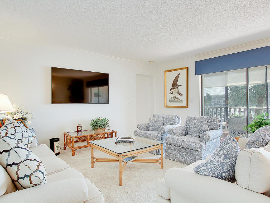 1880 Bay Road, Unit 220I Vero Beach, FL 32963 - Photo 4 of 35 a living room with furniture and a flat screen tv