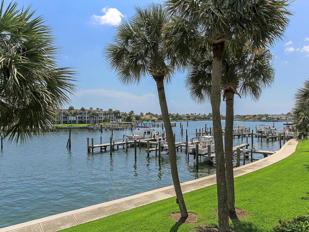1880 Bay Road, Unit 220I Vero Beach, FL 32963 - Photo 8 of 35 a view of a swimming pool with a table and chair