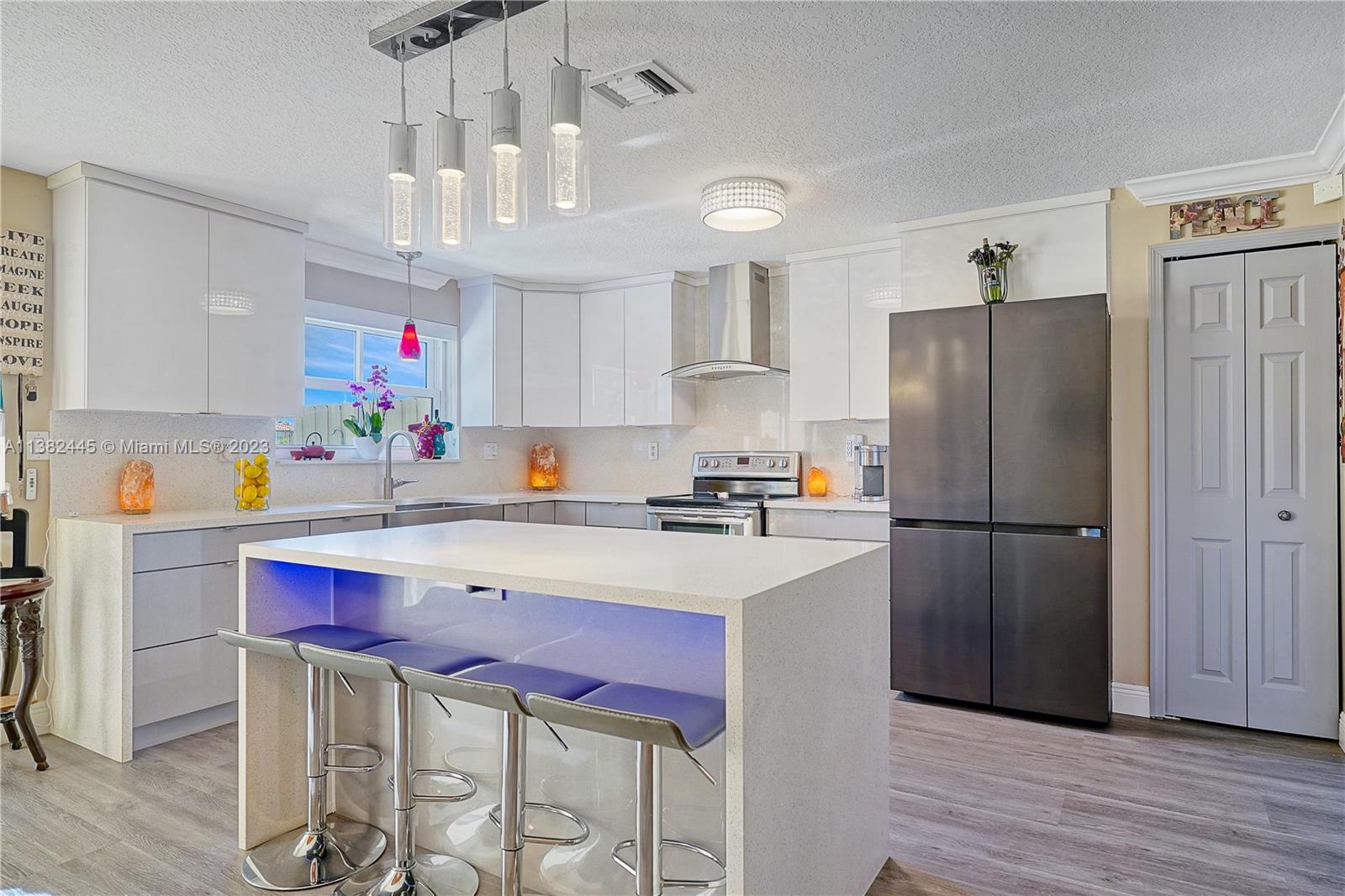 3078 Southwest 153rd Path, Unit 3078 Miami, FL 33185 - Photo 14 of 36 a kitchen with a refrigerator a sink dishwasher and a stove with wooden floor
