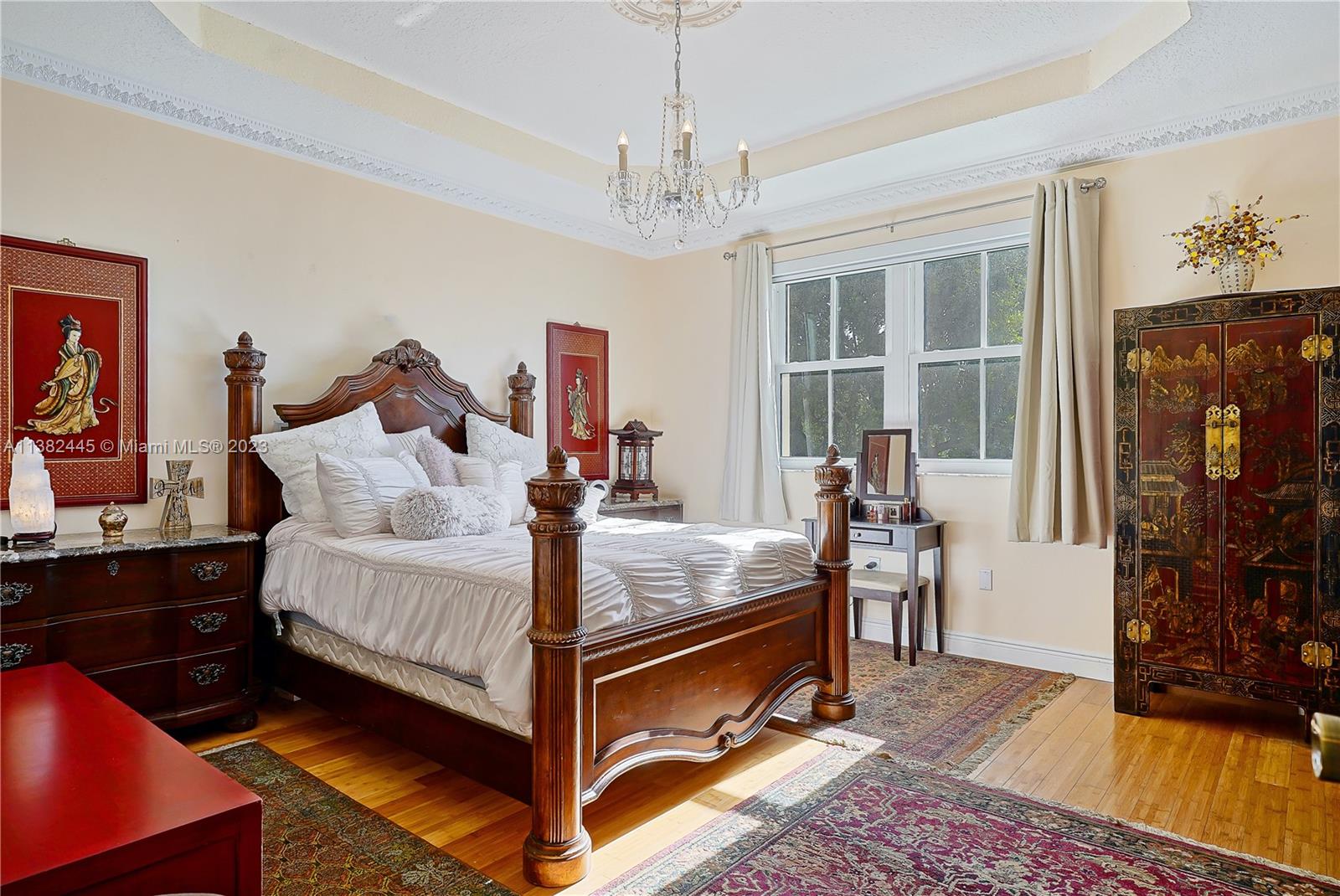 3078 Southwest 153rd Path, Unit 3078 Miami, FL 33185 - Photo 20 of 36 a bed room with a bed and a chandelier