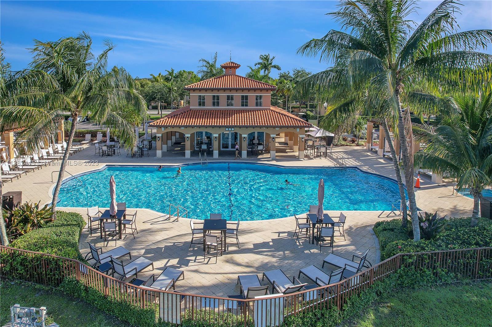 3078 Southwest 153rd Path, Unit 3078 Miami, FL 33185 - Photo 34 of 36 a view of a patio with table and chairs potted plants and palm tree