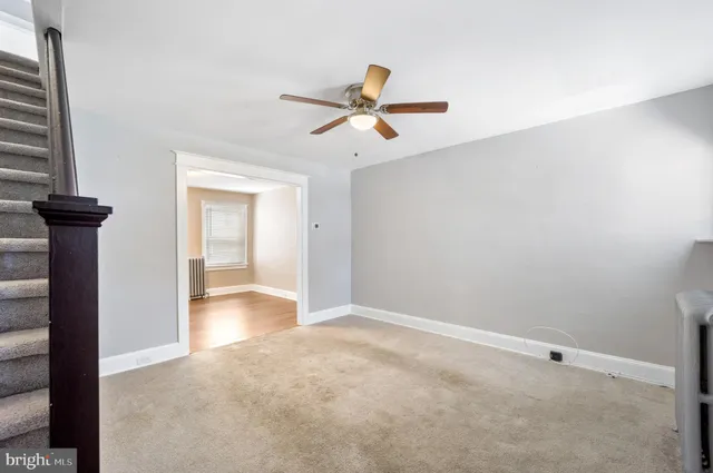a view of empty room with ceiling fan