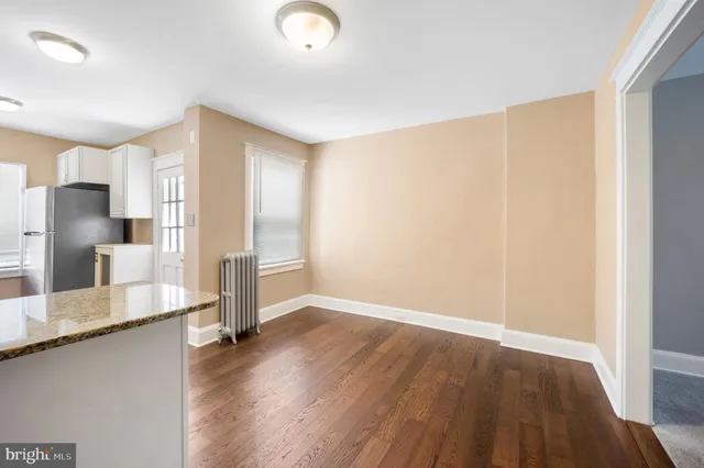 a view of a kitchen with wooden floor