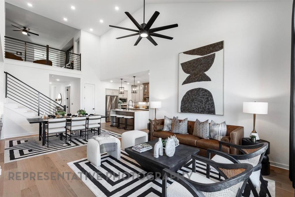 2132 Nerello Way Rockwall, TX 75032 - Photo 13 of 40 a living room with furniture a rug and a chandelier